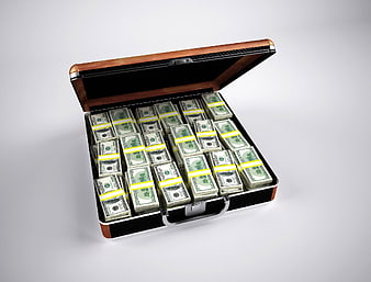 Open briefcase filled with stacks of cash on white background