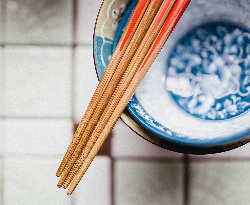 Bamboo Chopsticks on Blue and White Ceramic Bowl
