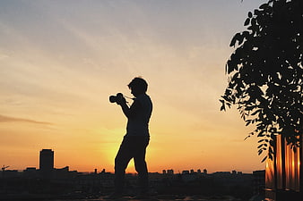 Silhouette of Photographer Taking Photo at Sunset