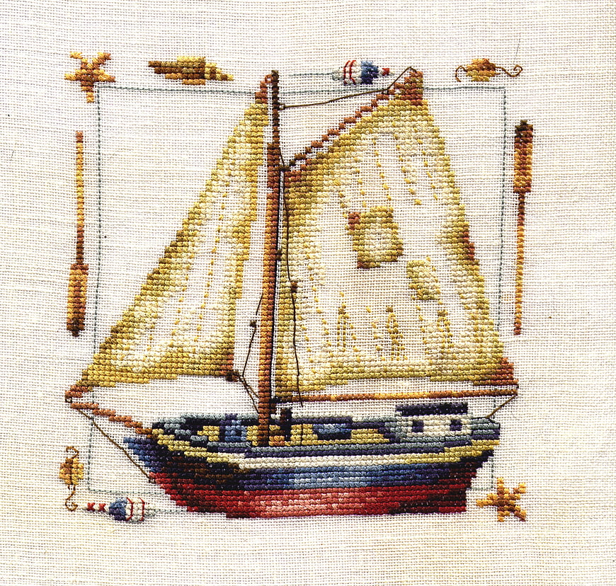 Cross-stitch embroidery of a vintage sailing ship on fabric