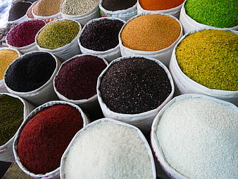 Colorful sacks of spices and grains at a market stall