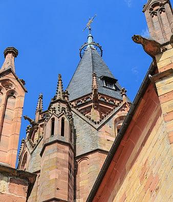 Gothic church tower spire against blue sky