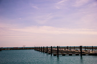 Serene marina with wooden docks and pastel sky
