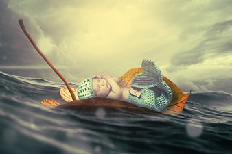 Sleeping baby mermaid on leaf boat in fantasy ocean