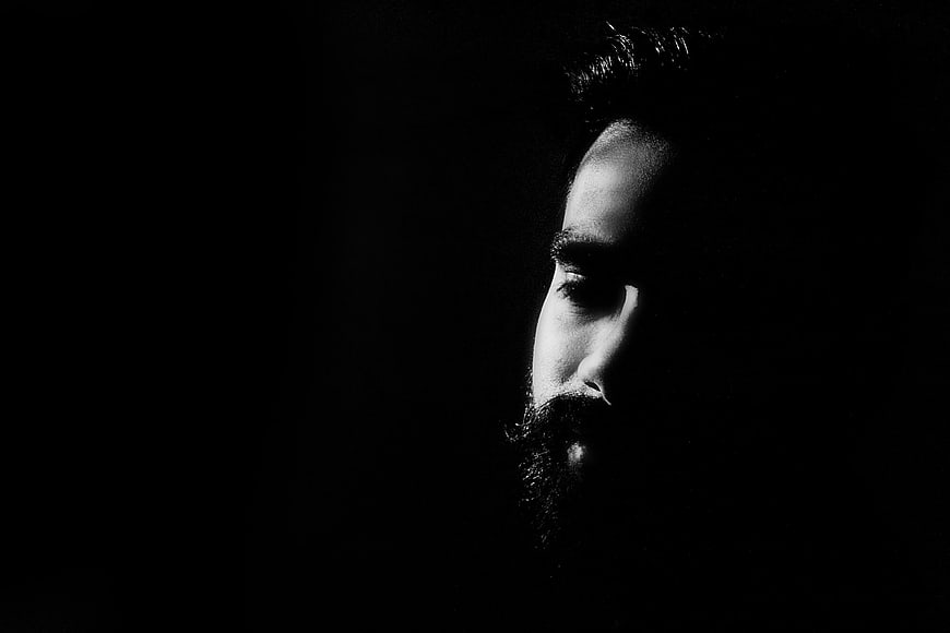 Dramatic Black and White Portrait of Bearded Man in Shadows