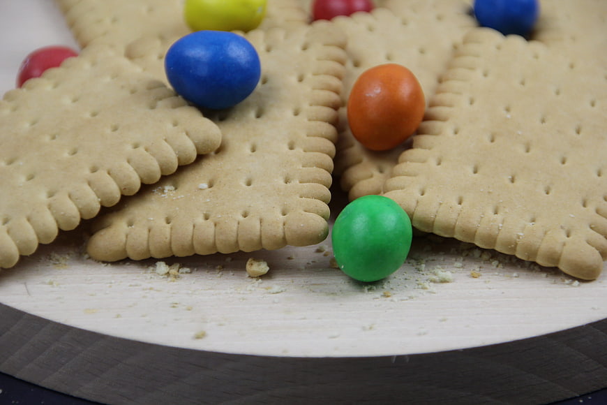 Close-up of square crackers with colorful candy balls