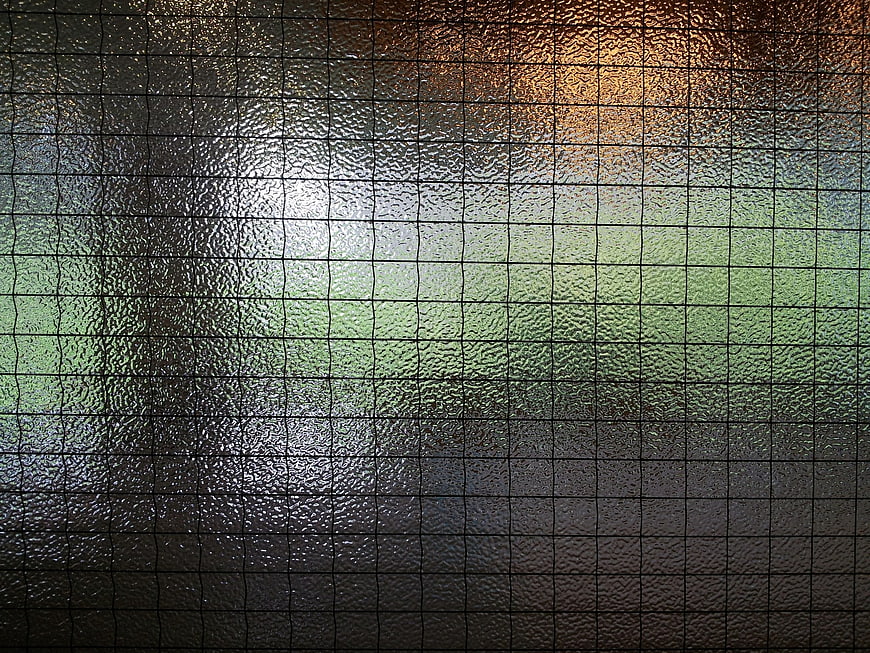 Abstract Textured Glass Surface With Grid Pattern And Colorful Light