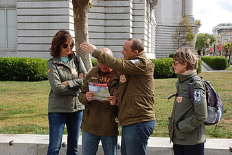 Group of tourists in Route 66 jackets consulting a map outdoors