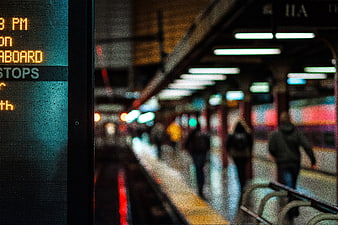 Close-up of subway train digital display with blurred station background