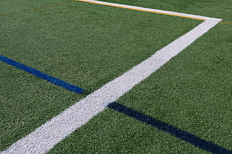 Close-up of artificial turf field with white and blue lines