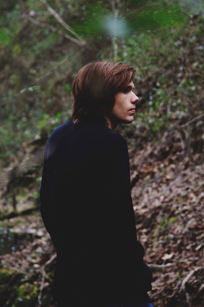 Profile Portrait of Young Man in Forest