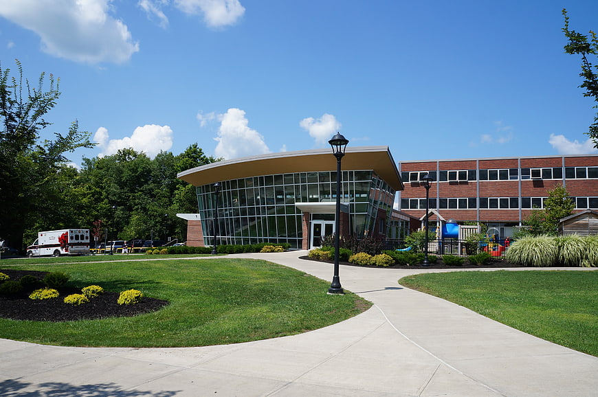 Modern University Campus Building Exterior With Landscaped Walkway