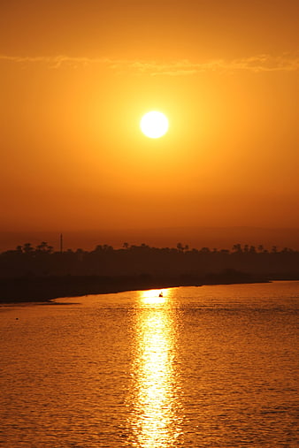 Golden Sunset Over The Nile River With Silhouetted Landscape