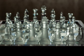 Frosted Glass Chess Pieces on a Board