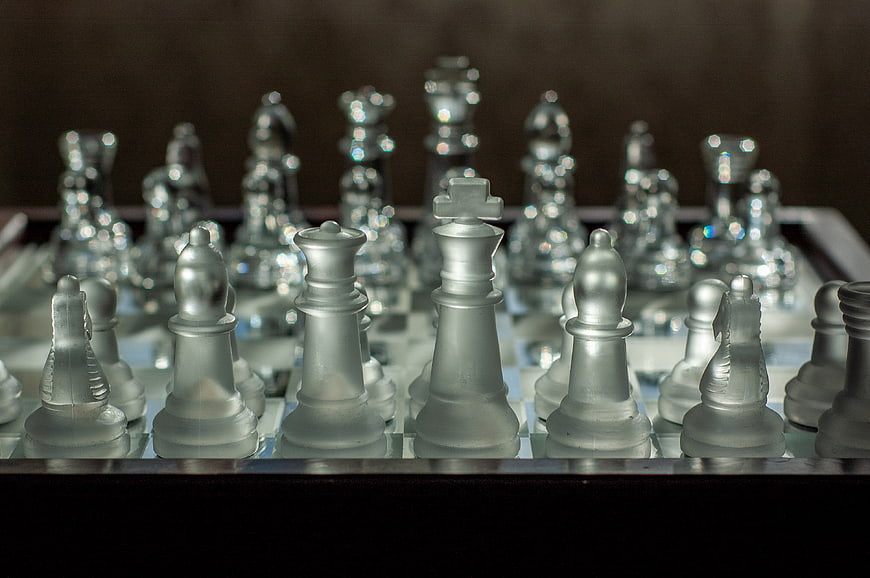 Frosted Glass Chess Pieces on a Board