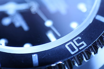 Close-up of blue watch bezel with number 50