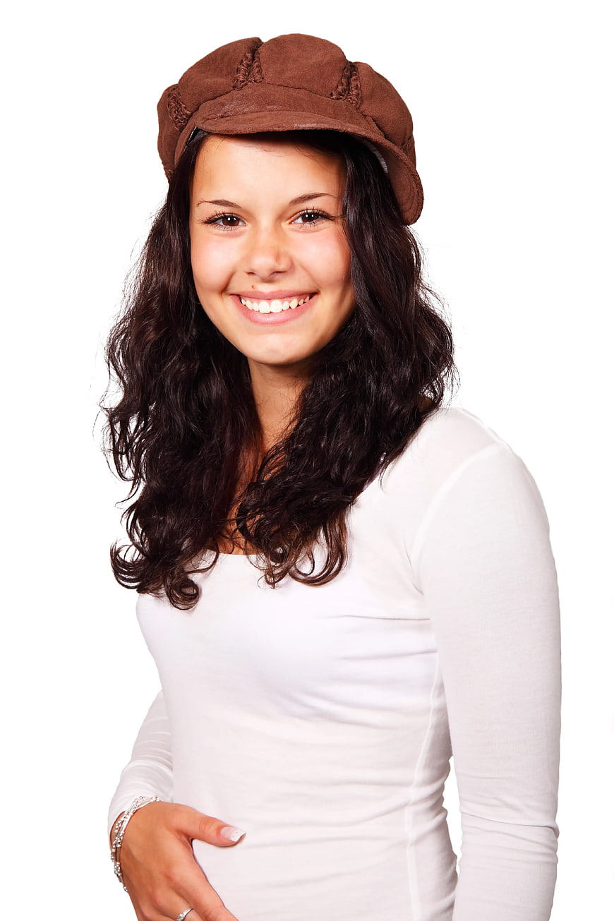 Smiling Woman in Brown Cap and White Shirt