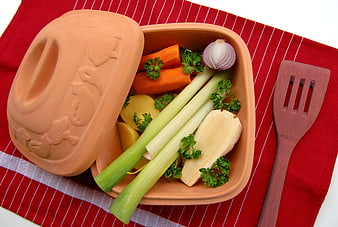 Roman Pot With Fresh Vegetables And Wooden Spatula On Red Cloth