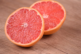 Fresh Cut Red Grapefruit Halves on Wooden Table
