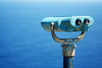 Blue Coin-Operated Binoculars Overlooking the Ocean