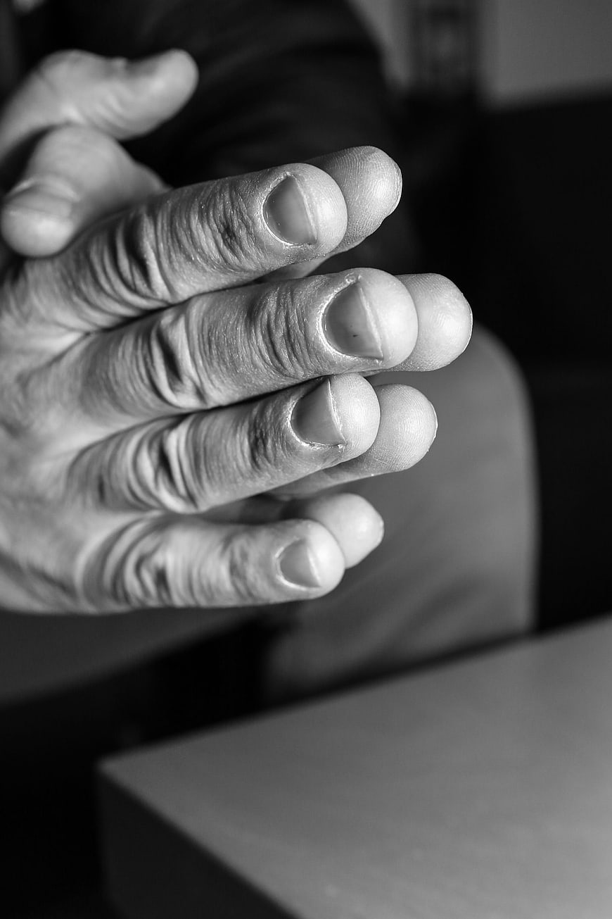 Close-up of wrinkled hand with textured skin in black and white