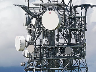 Telecommunication tower with multiple satellite dishes and antennas
