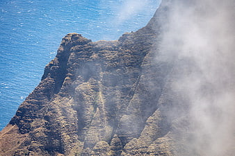 Misty coastal cliffs overlooking the deep blue ocean
