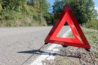 Red Warning Triangle On Country Road Shoulder
