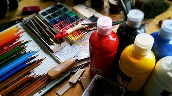 Colorful Art Supplies and Painting Tools on Wooden Table