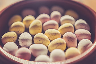 Close-up of speckled Easter eggs in a wooden bowl