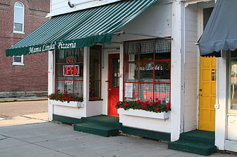 Mama Linda's Pizzeria storefront with green awning and red flowers