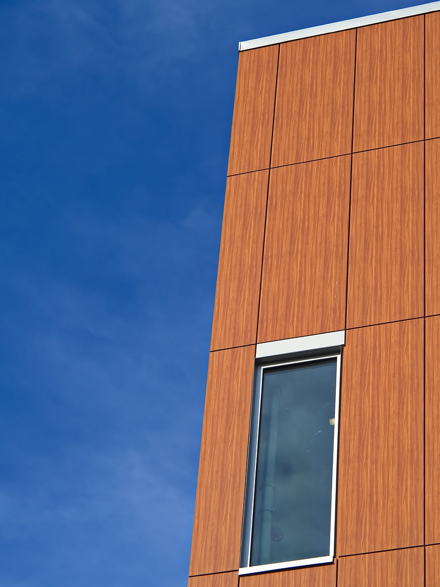 Modern wooden facade building against blue sky