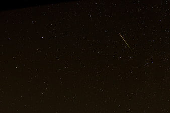 Shooting Star Streak Across Dark Starry Night Sky