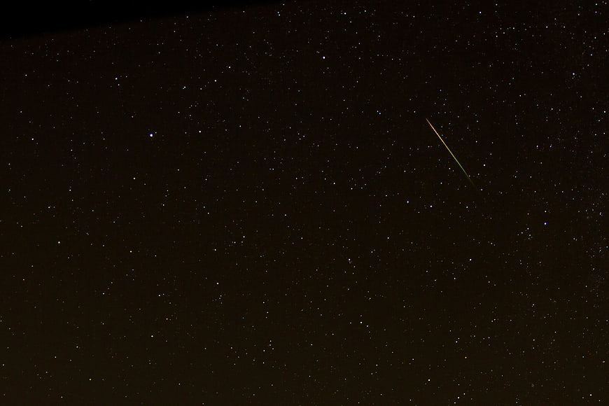Shooting Star Streak Across Dark Starry Night Sky
