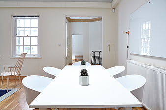Minimalist white meeting room with modern table and chairs