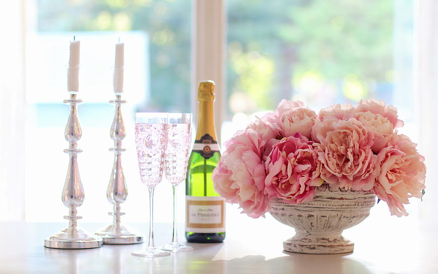 Pink Peonies, Champagne, and Silver Candlesticks on a Table