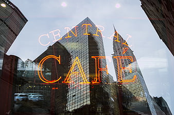 Central Cafe Neon Sign Reflected in City Glass Window