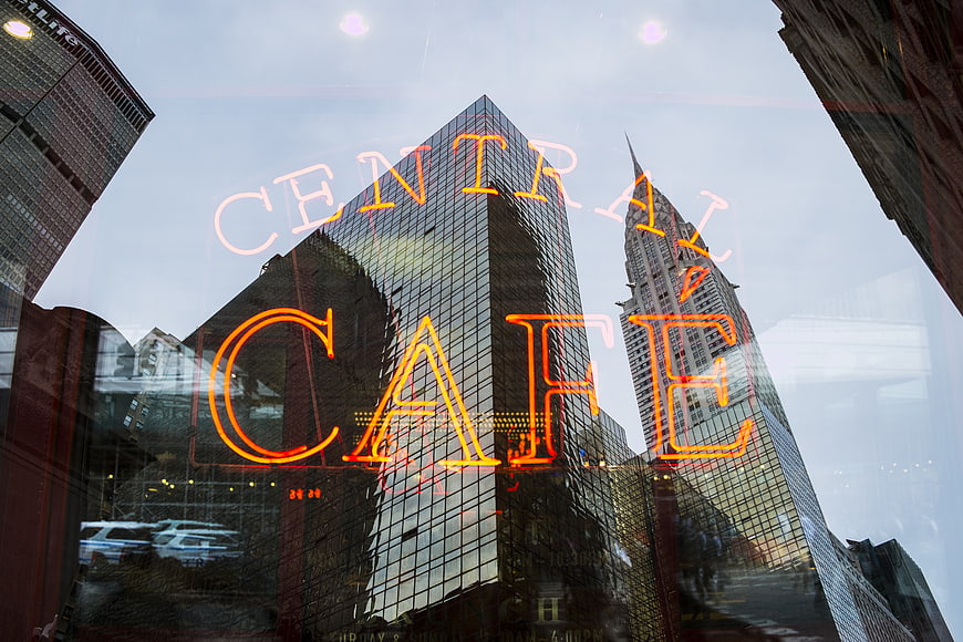 Central Cafe Neon Sign Reflected in City Glass Window