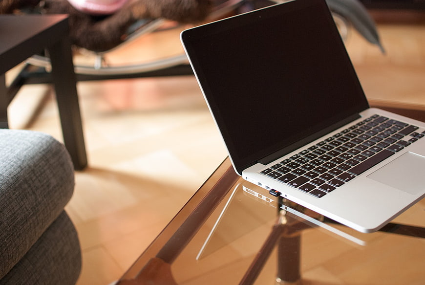 Silver laptop on glass table in modern living room