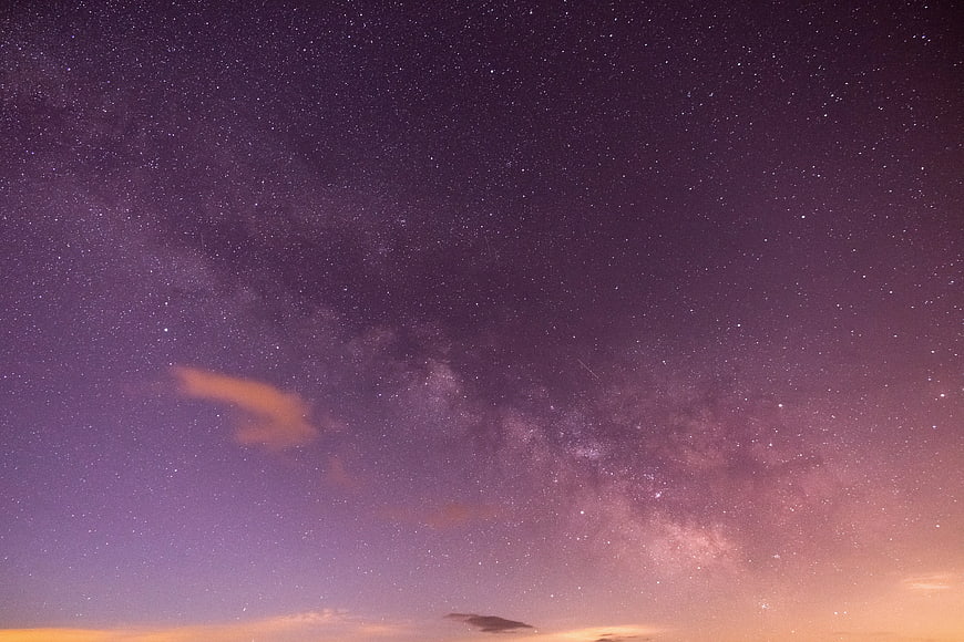 Purple Milky Way Night Sky with Stars and Clouds
