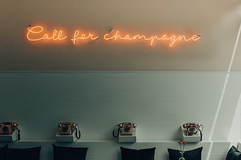 Vintage Neon Sign and Retro Telephones on Wall