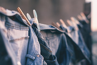 Denim Jeans Hanging on Clothesline with Wooden Pins