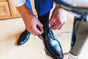 Businessman Tying Black Leather Dress Shoes