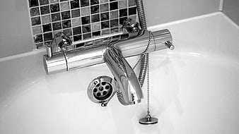 Chrome Bathroom Faucet Close-Up With Mosaic Tile Background
