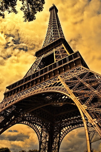 Low Angle View of Eiffel Tower Against Golden Cloudy Sky