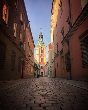 Cobblestone Alley Leading to Historic Church Tower