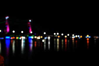 Abstract Bokeh City Lights Reflected on Water at Night