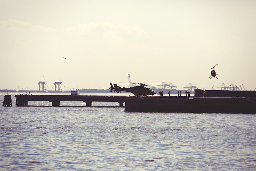 Helicopters Landing on Harbor Dock with Cranes