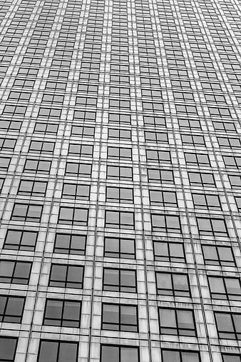 Black and white skyscraper facade with geometric window pattern