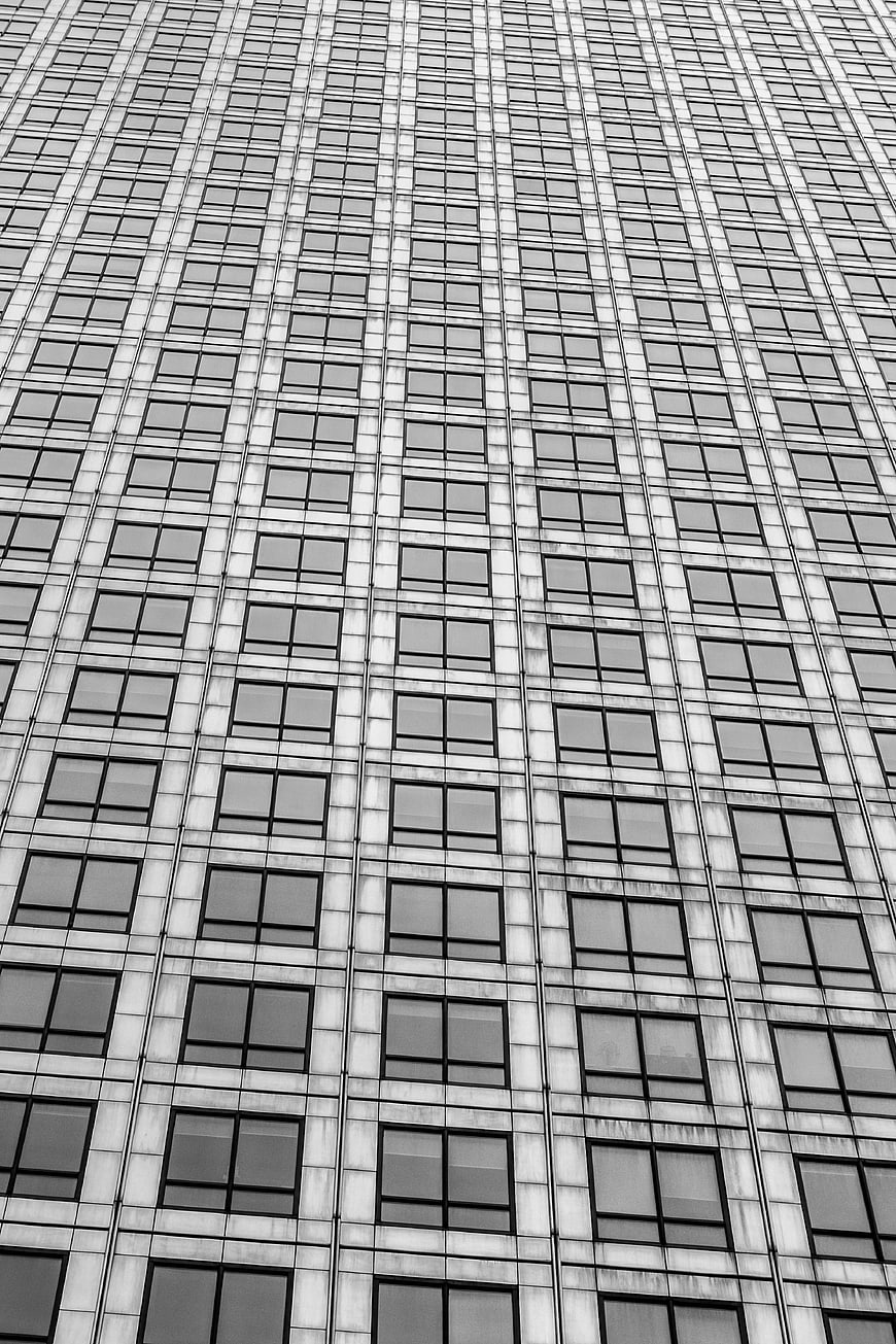 Black and white skyscraper facade with geometric window pattern